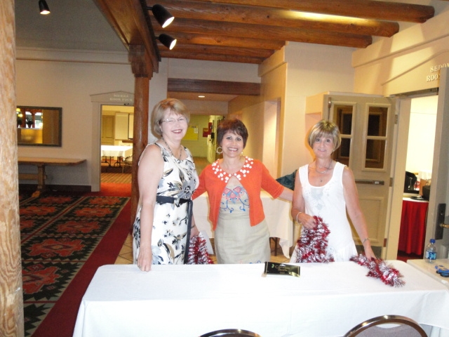 Lucille, Carolyn and Trudy decorating the registration table. 